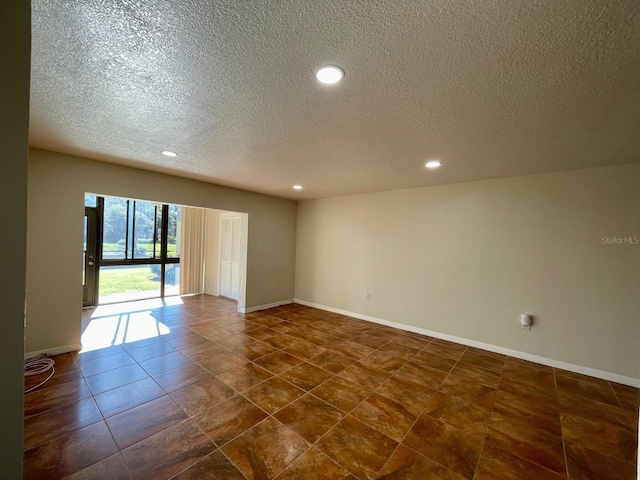 empty room with a textured ceiling