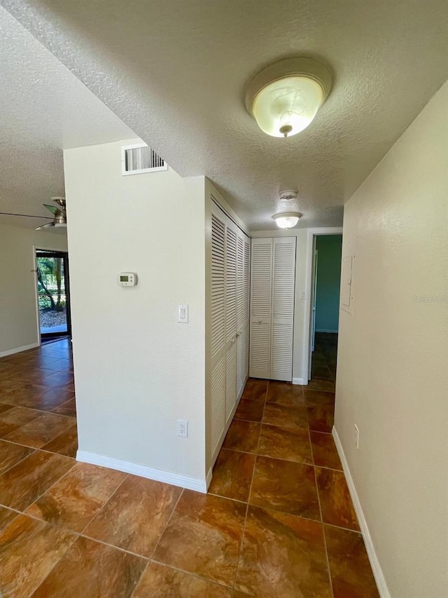 hallway featuring a textured ceiling