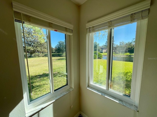 unfurnished sunroom with a water view