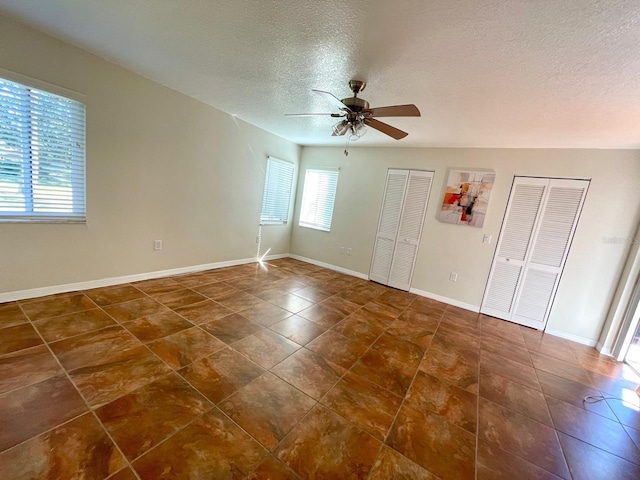 spare room featuring ceiling fan and a textured ceiling