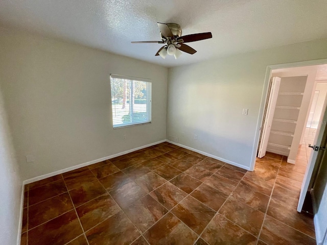 empty room featuring a textured ceiling and ceiling fan