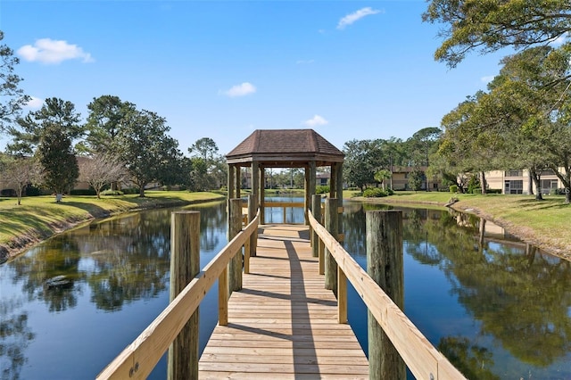 view of dock with a gazebo and a water view