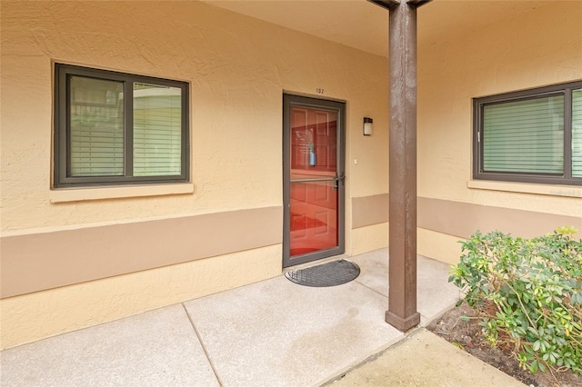 entrance to property featuring a patio