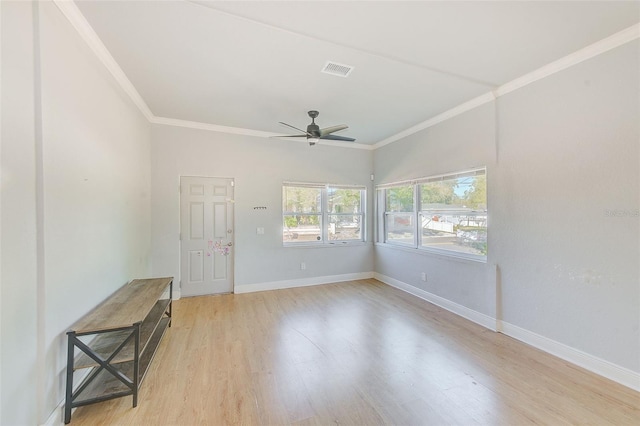 spare room featuring ceiling fan, ornamental molding, and light hardwood / wood-style flooring