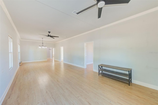 empty room featuring ceiling fan with notable chandelier, light hardwood / wood-style floors, and ornamental molding