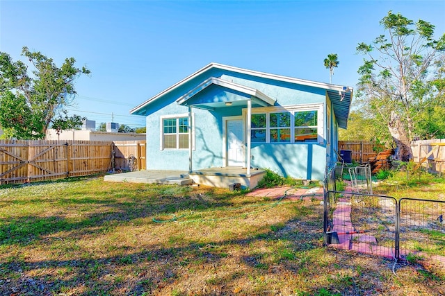 rear view of property with a lawn