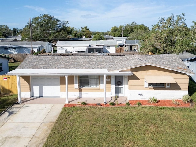 ranch-style house with a garage and a front lawn