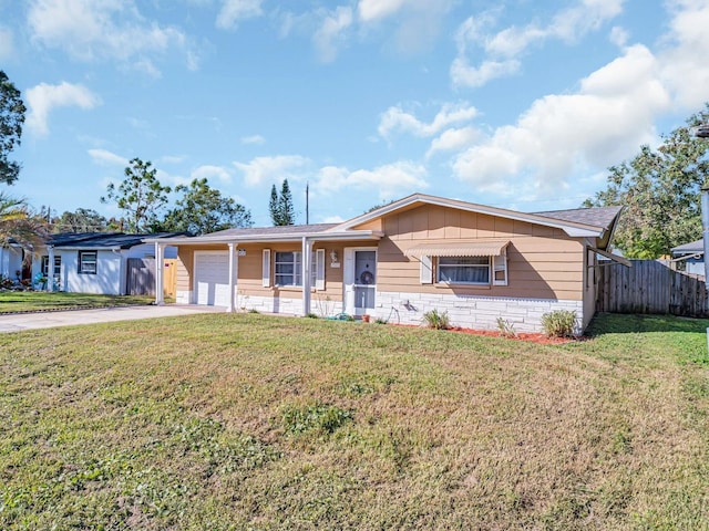 single story home featuring a garage and a front lawn