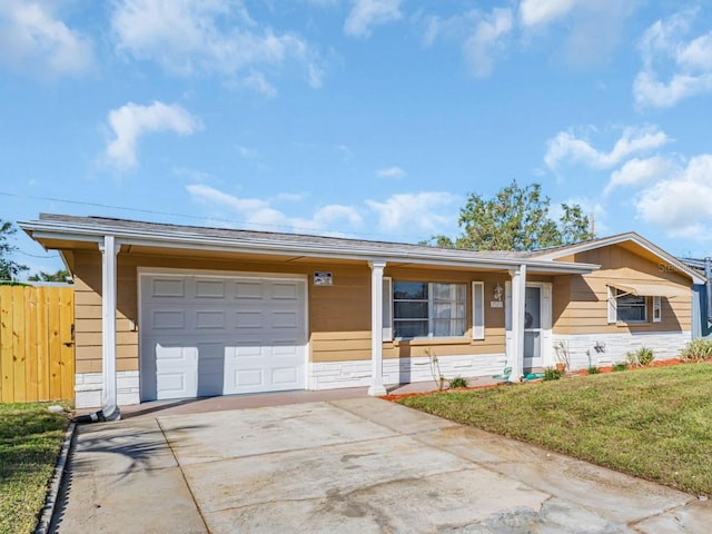 single story home with a garage and a front lawn