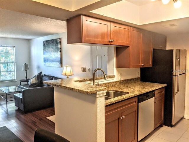 10200 Gandy Blvd N Unit 921, Saint Petersburg, FL 33702 - kitchen with appliances with stainless steel finishes, a sink, light stone countertops, a peninsula, and open floor plan