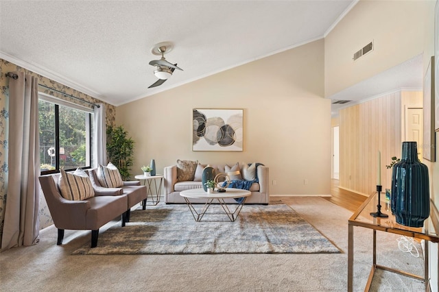 living room featuring a textured ceiling, high vaulted ceiling, crown molding, and carpet