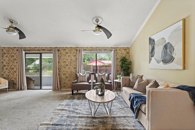 carpeted living room with ceiling fan, a healthy amount of sunlight, ornamental molding, and a textured ceiling