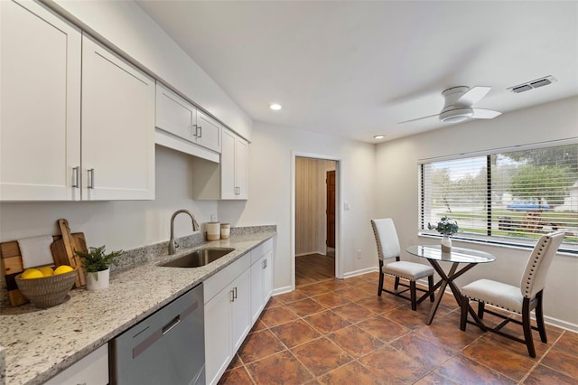 kitchen featuring dishwasher, light stone countertops, white cabinetry, and sink