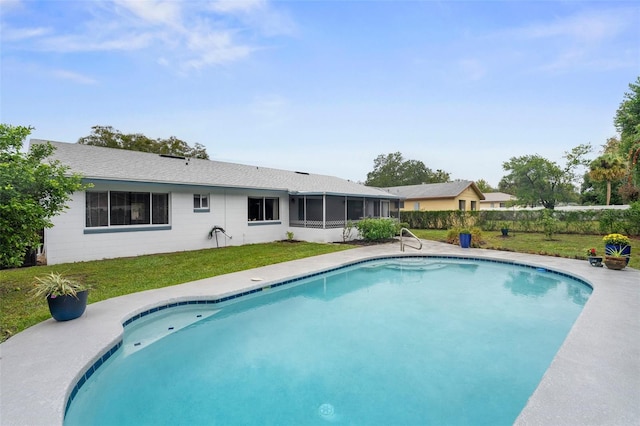 view of pool featuring a lawn and a sunroom