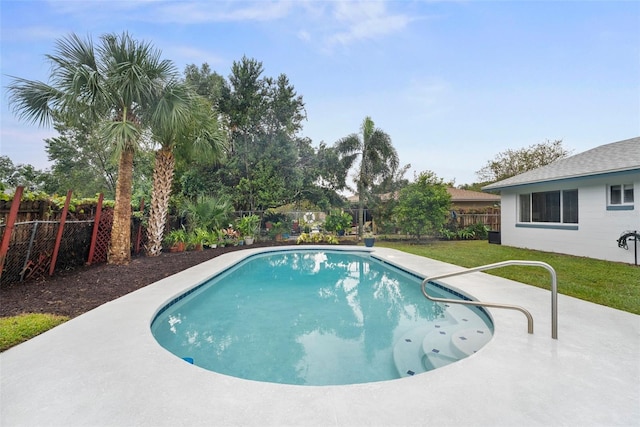 view of swimming pool with a patio area and a yard