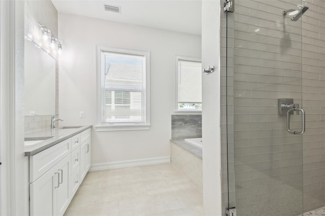 bathroom with vanity, separate shower and tub, and a wealth of natural light