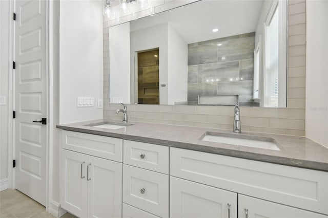 bathroom featuring vanity and backsplash