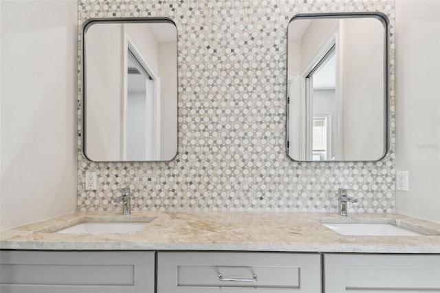 bathroom with tasteful backsplash and vanity