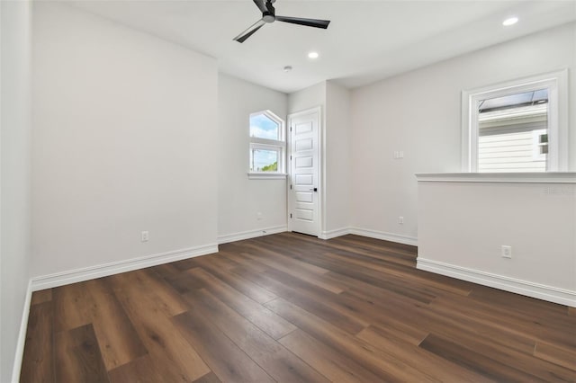 unfurnished room featuring dark hardwood / wood-style floors and ceiling fan