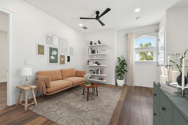 sitting room featuring ceiling fan and dark wood-type flooring