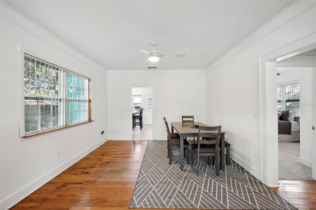 dining room featuring hardwood / wood-style floors, plenty of natural light, ornamental molding, and ceiling fan