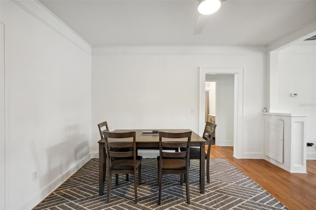 dining area with crown molding and hardwood / wood-style floors