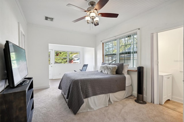 bedroom featuring light colored carpet, ceiling fan, and ornamental molding