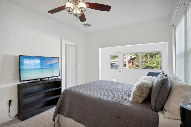 bedroom featuring carpet floors, ceiling fan, and crown molding