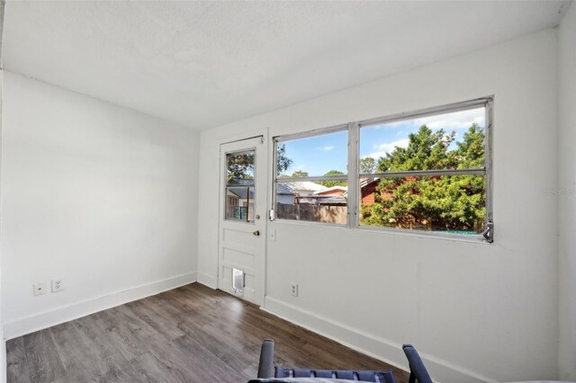 spare room with hardwood / wood-style floors and a textured ceiling