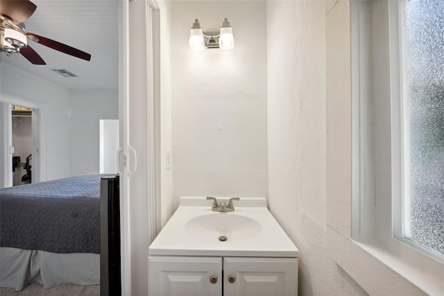 bathroom featuring ceiling fan and vanity