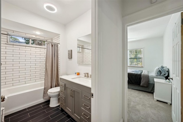 full bathroom featuring plenty of natural light, toilet, shower / bath combo, and vanity