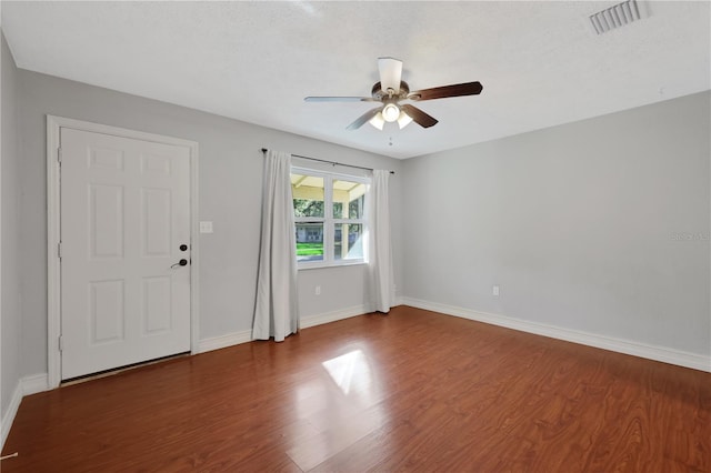 spare room with ceiling fan and dark hardwood / wood-style floors