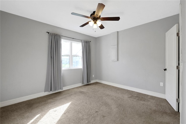 empty room with ceiling fan and carpet flooring