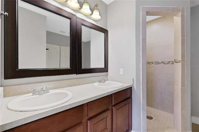 bathroom with vanity and tiled shower