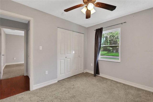 unfurnished bedroom featuring ceiling fan, a closet, and carpet floors