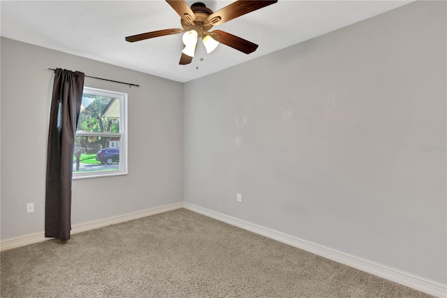 unfurnished room featuring ceiling fan and light carpet