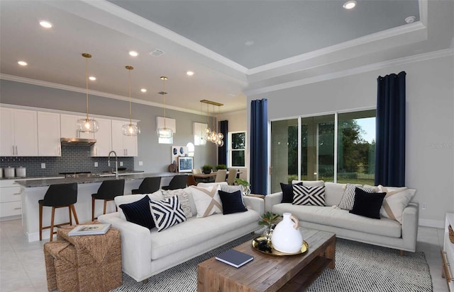 living room featuring light tile patterned flooring, ornamental molding, and sink