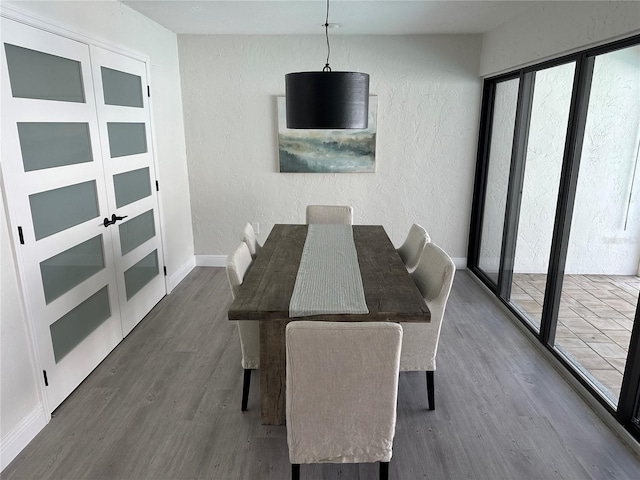 3963 Glen Oaks Manor Dr, Sarasota, FL 34232 - dining area with dark wood finished floors, a textured wall, and baseboards