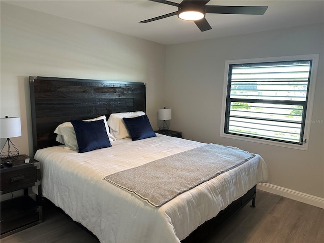 bedroom with dark hardwood / wood-style floors and ceiling fan