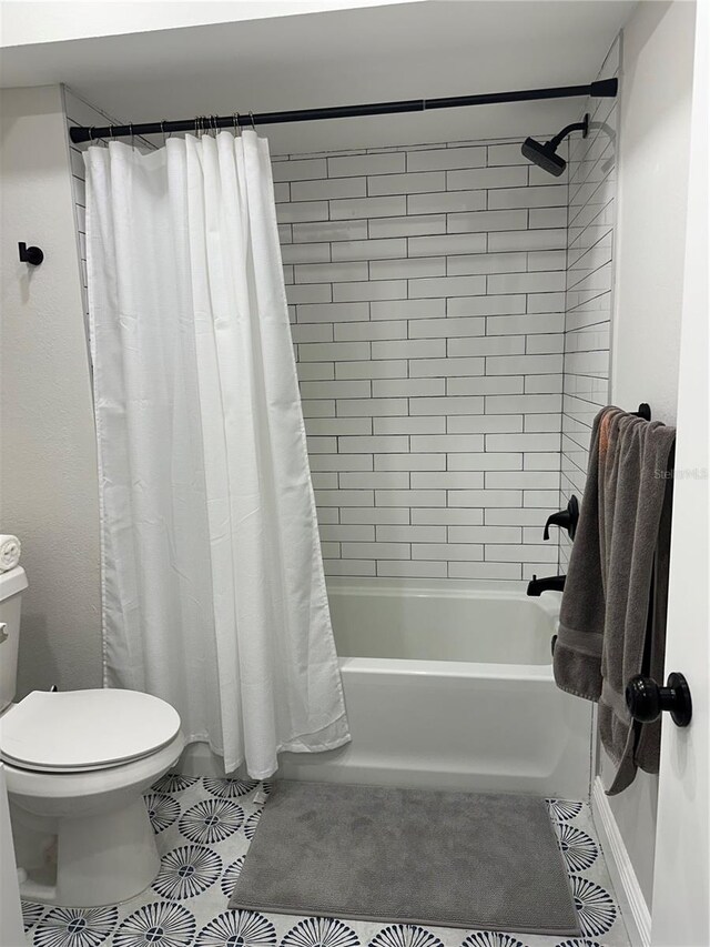 bathroom with toilet, tile patterned floors, and shower / bath combo with shower curtain