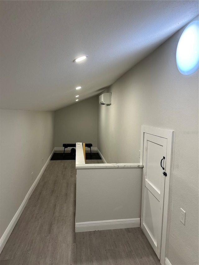 bar with a wall mounted air conditioner and dark hardwood / wood-style floors