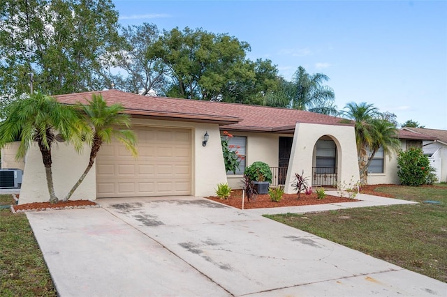 ranch-style home with a front lawn, a garage, and central AC unit