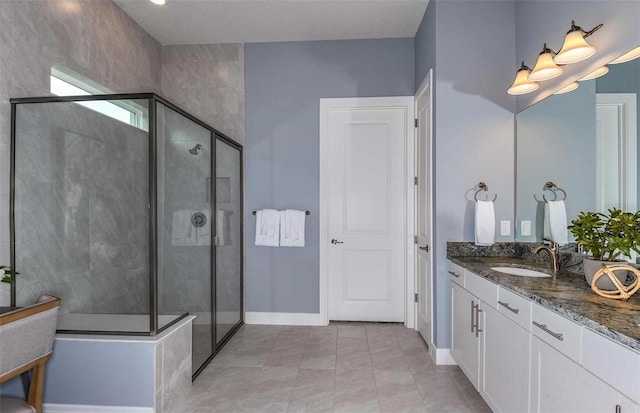 bathroom featuring tile patterned flooring, vanity, and a shower with shower door