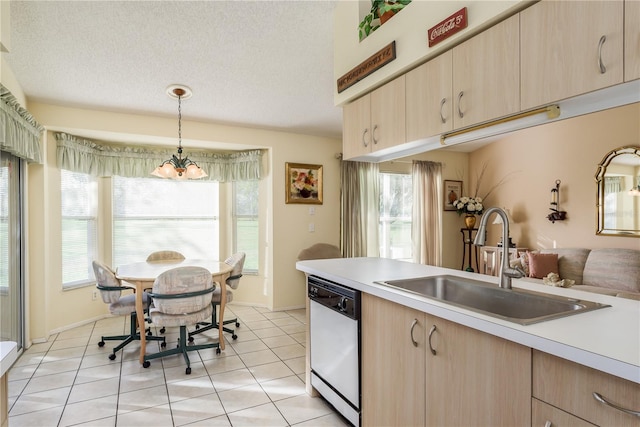 kitchen with sink, light brown cabinets, a notable chandelier, dishwasher, and hanging light fixtures