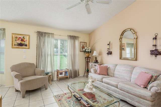 tiled living room featuring ceiling fan and a textured ceiling