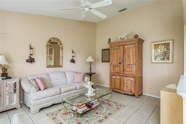 tiled living room featuring ceiling fan and a textured ceiling