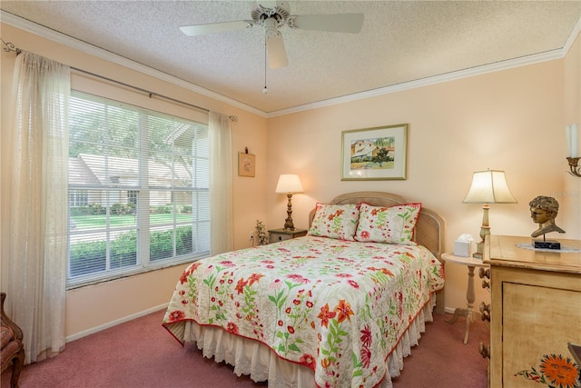 bedroom featuring carpet flooring, a textured ceiling, ceiling fan, and crown molding