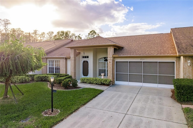 ranch-style home featuring a front lawn and a garage