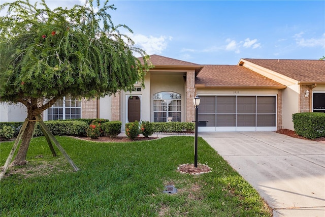 single story home with a garage and a front lawn