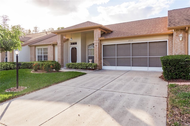 ranch-style house featuring a garage and a front lawn